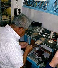 silver school - Maestro Lopez helps a student set a stone in their project