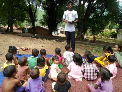 KKC kids listeing to exciting bible stories from the teacher Manasha